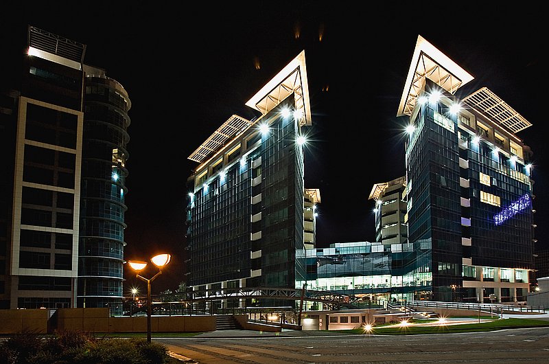 This picture shows the Sava Business Center in Belgrade at night from the outside.